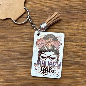 Chic January Girl Keychain with Tan Tassel